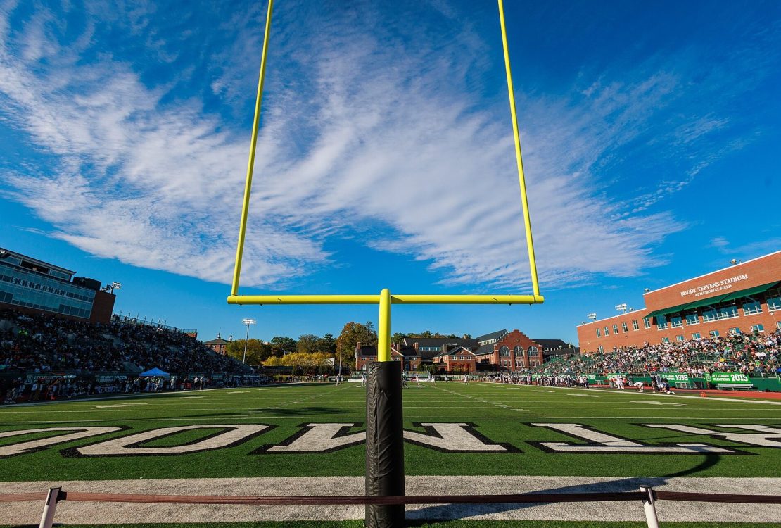 American football field goalposts seen close up against the sky