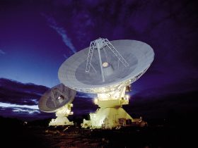 Large radio telescope dishes against the sky