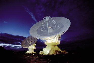 Large radio telescope dishes against the sky