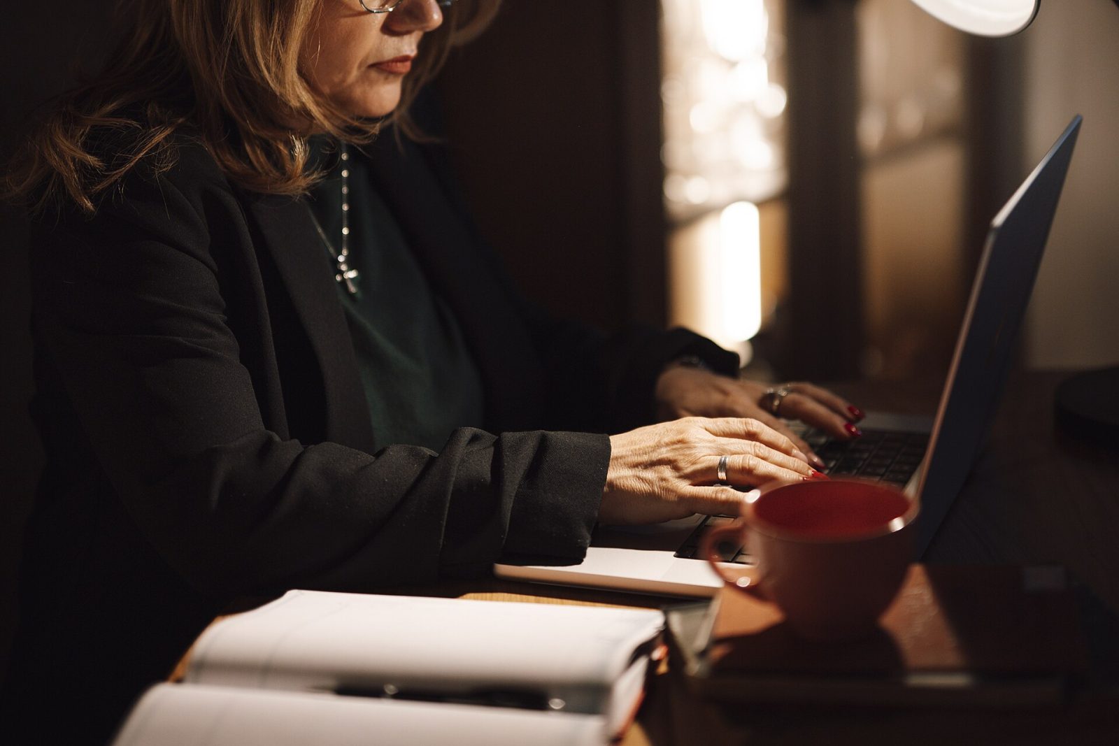 A person reading an email newsletter on a phone over morning coffee